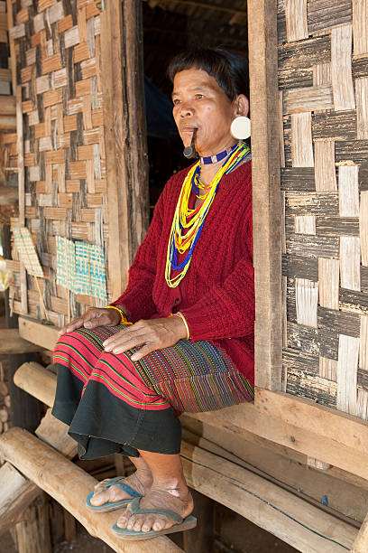 istock old woman with pipe in Asia 115072513