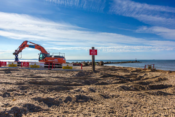 Work in progress to replace the groyne at Hengistbury Head known as the "u2018Long Groyne"u2019 Hengistbury head, Dorset / United Kingdom - May 21, 2019: work in progress to replace the groyne at Hengistbury Head known as the ‘Long Groyne’ part of the 17-year plan to protect Bournemouth’s coastline during 2015 to 2032 hengistbury head photos stock pictures, royalty-free photos & images