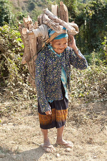 istock old woman Asia carry firewood 115072598