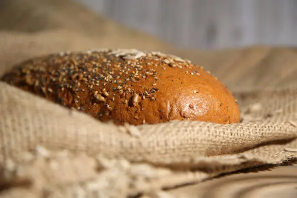 Loaf of grain bread on a jute sack
