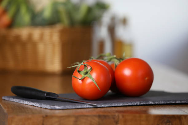 istock Group of tomatoes on a cutting board in the kitchen 1150726296