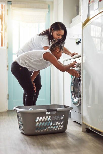 istock Showing her how to operate the washing machine 1150727407