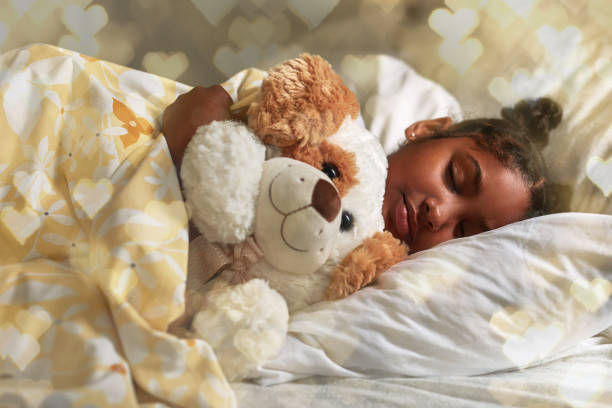 I can't sleep without my teddy Shot of an adorable young girl sleeping peacefully in her bed little black girl hairstyle stock pictures, royalty-free photos & images
