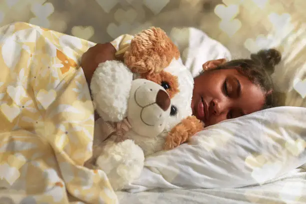 Shot of an adorable young girl sleeping peacefully in her bed