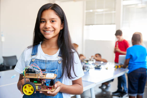 istock Portrait Of Female Student Building Robot Vehicle In After School Computer Coding Class 1150727499