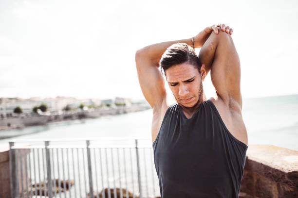 istock fitness man stretching the arm 1150728938