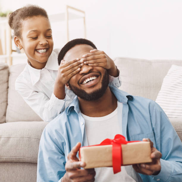 istock Girl closing father's eyes and giving present box 1150729028