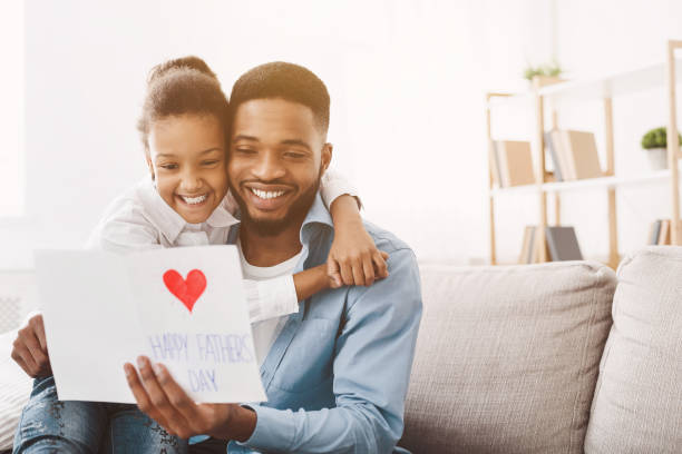 istock Happy father's day. Daughter congratulating dad at home 1150729030