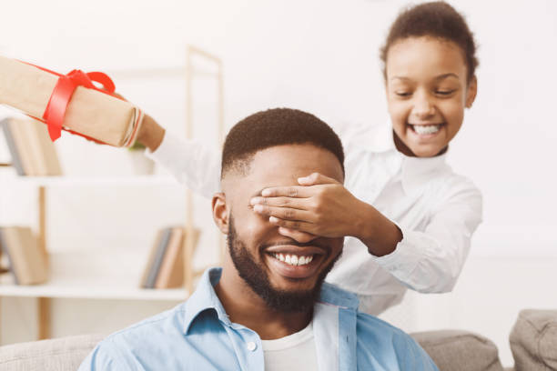istock Little daughter giving birthday present to daddy 1150729035