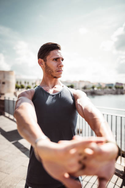 istock fitness man stretching the arm 1150729042