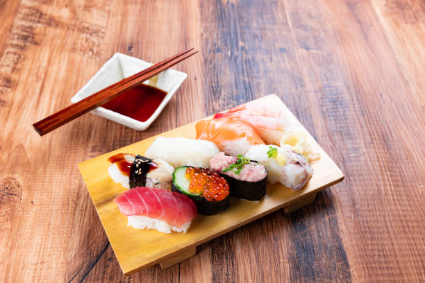 nigiri sushi on wooden board - sushi sashimi nigiri salmon imagens e fotografias de stock