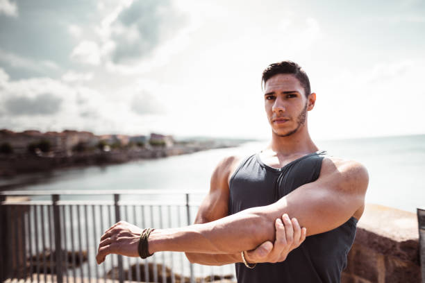 istock fitness man stretching the arm 1150729178