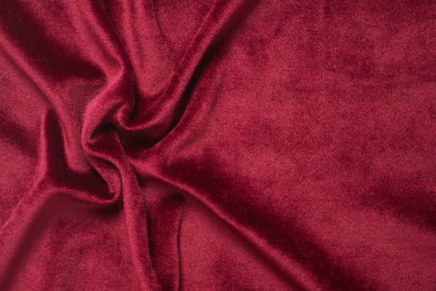 istock Red velvet background. Abstract textile texture with waves. Copy space. Flat lay 1150729428