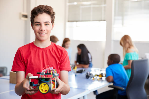 istock Portrait Of Male Student Building Robot Vehicle In After School Computer Coding Class 1150729851