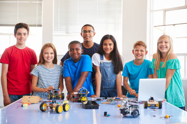 istock Portrait Of Students With Teacher Building Robot Vehicle In After School Computer Coding Class 1150729941
