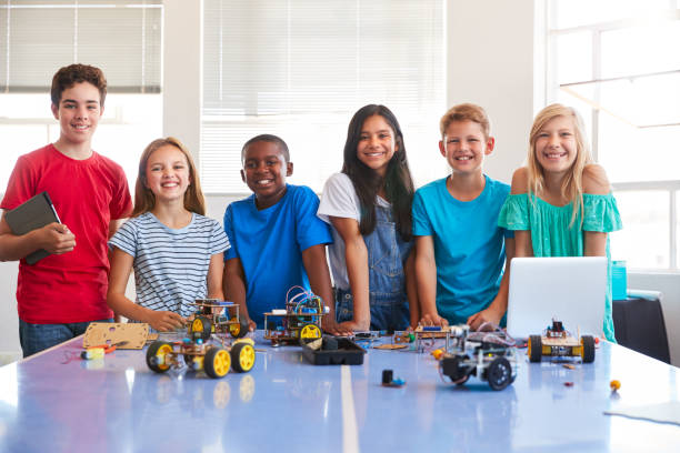 portrait of male and female students building robot vehicle in after school computer coding class - male african descent africa ethnic imagens e fotografias de stock