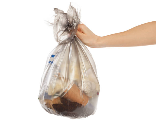 istock woman hands holding garbage bag isolated on white background 1150731112