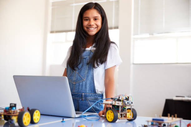 istock Portrait Of Female Student Building And Programing Robot Vehicle In School Computer Coding Class 1150731249
