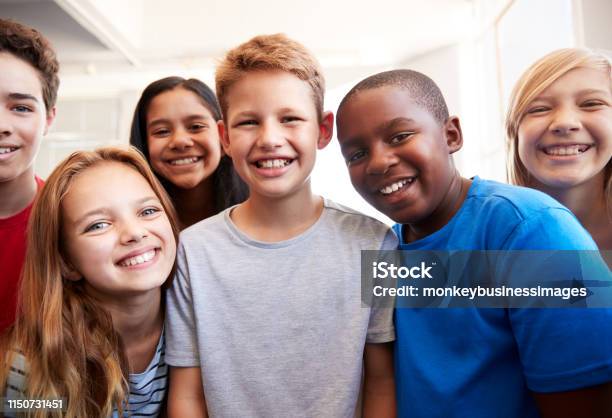 Portrait Of Smiling Male And Female Students In Grade School Classroom Stock Photo - Download Image Now