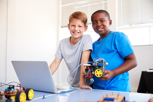 Portrait Of Two Male Students Building And Programing Robot Vehicle In ...