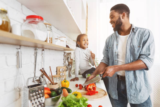 istock Dad and daughter cooking together 1150731684