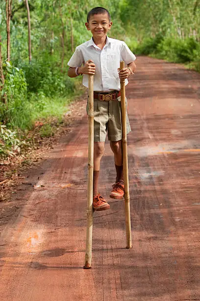 Boy goes on stilts, thai child with school uniform with his hobby