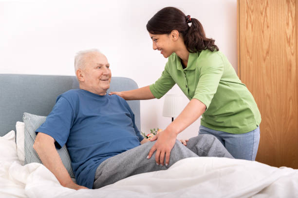 istock Home caregiver helping senior man 1150732510