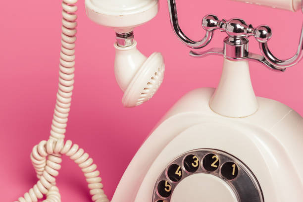 istock Retro white telephone on pink background 1150732659