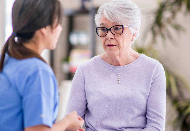 istock Sad senior woman at doctor's office 1150732834