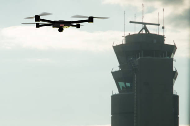 drone approaching the airport control tower stock photo