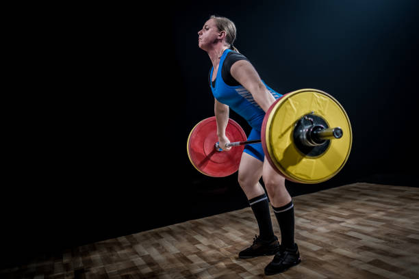 istock Woman lifting barbell 1150738354