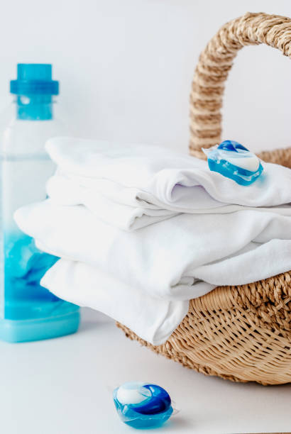 istock Stack of clothes and laundry pods in a basket at home 1150739508