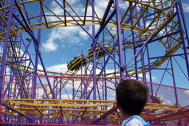 Boy watches a fast roller coaster