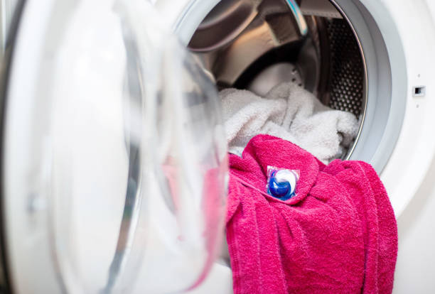 istock Washing machine with laundry and detergent pod 1150739791