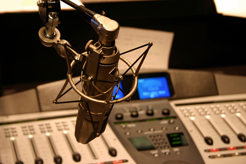 Radio station microphone in front of mixing board.  DESIGNERS... I would love to have you sitemail me and let me know how you use this image! Thank-you !