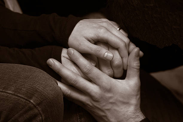 Friends support each other, holding hands - see portfolio for more of this series.
