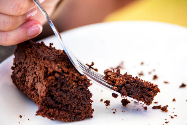 istock Eating a home made chocolate brownie dessert with a fork 1150742328