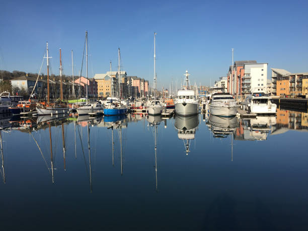 Marina yachts and cruisers reflected in still waters