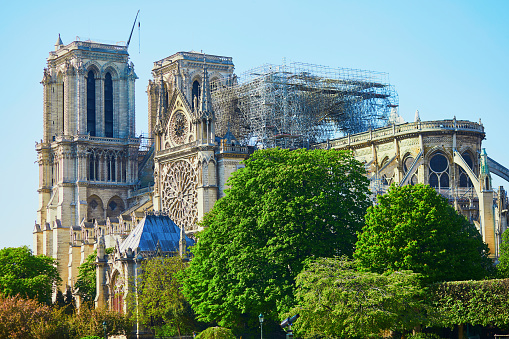 View of Notre Dame cathedral without roof and spire destroyed by fire in Paris, France