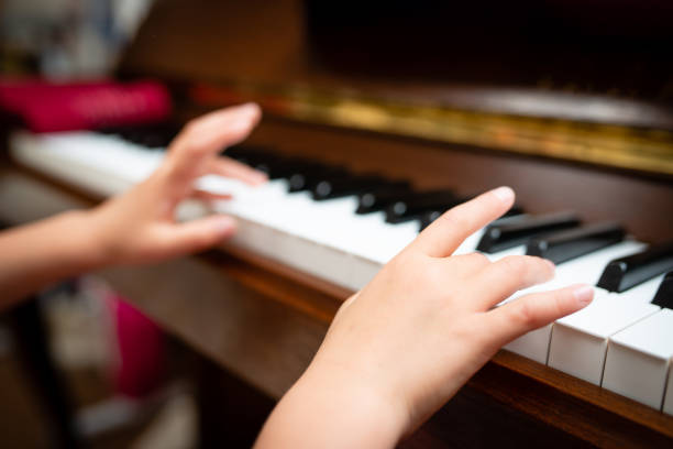 istock Child's hand playing the piano 1150744592
