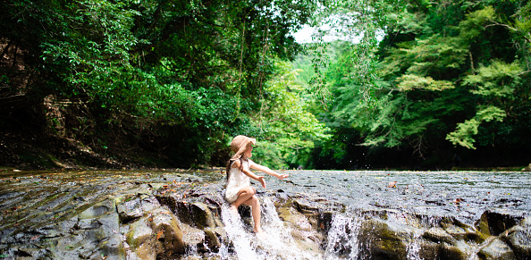 Girl playing in a mountain stream