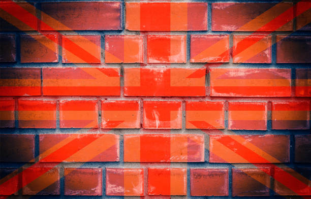 istock Old Flag of Great Britain pictured on a brick wall 1150746415
