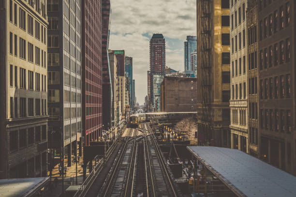 istock Elevated Train Tracks are running above the Railroad tracks between the building at the Loop line at Chicago, Illinois, USA 1150748395