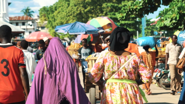 People walking in crowded market street of Stone Town, Zanzibar, Tanzania