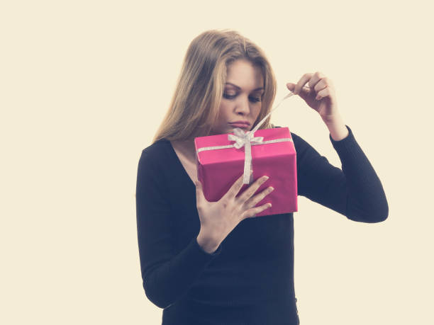 istock Girl opening pink gift box 1150754578
