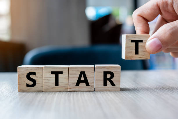 istock Business man hand holding wooden cube with START text on table background. Goals, success, strategy, solution and business concepts 1150755835