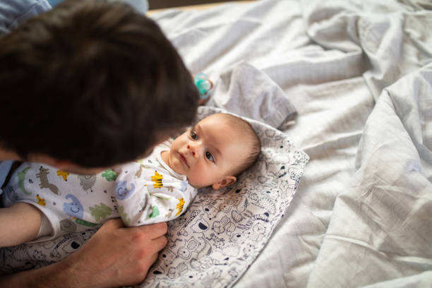 istock Daddy telling story to baby boy 1150755990