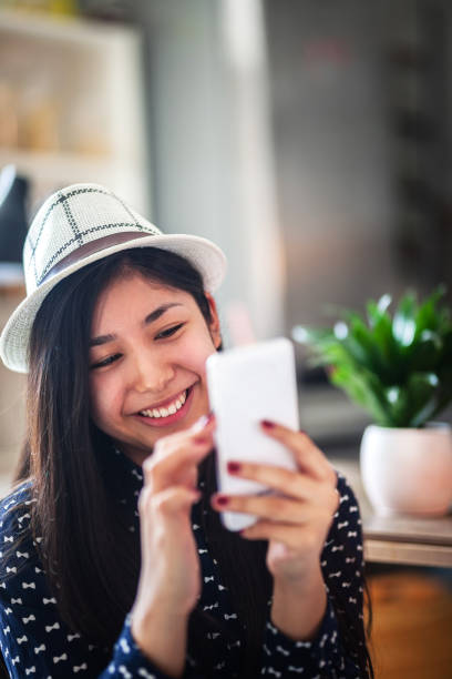 istock Young Asian woman using phone 1150756211