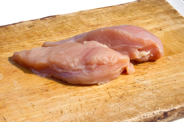 istock Fresh chicken on a wooden cutting board. 1150758338