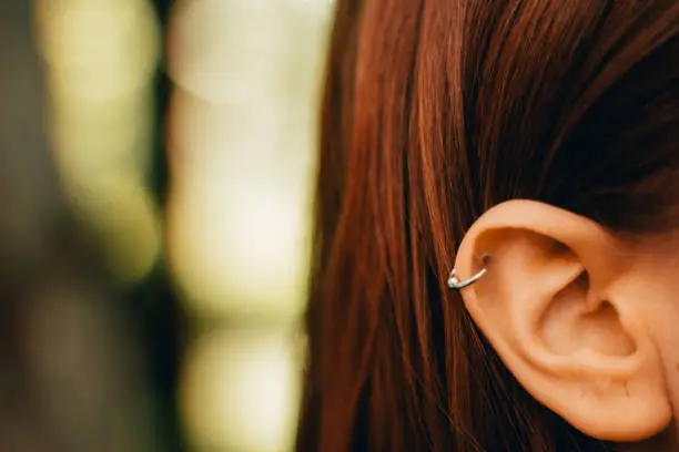 Photo of Closeup shot of a woman’s pierced ear